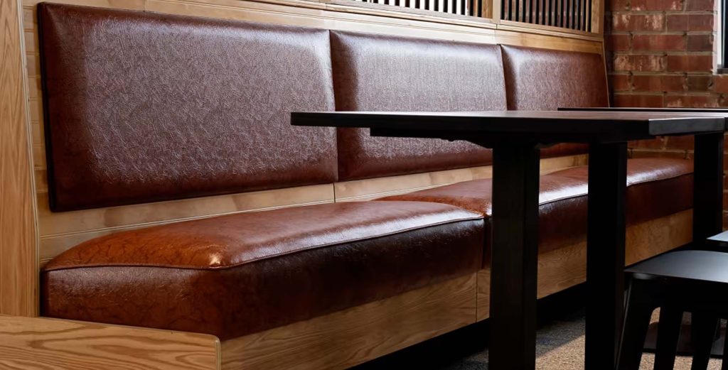 Custom Restaurant Booths | Design, Build & Installation Process 20255 Brown leather restaurant booth with solid wood base and padded seating, ideal for modern and rustic dining interiors.