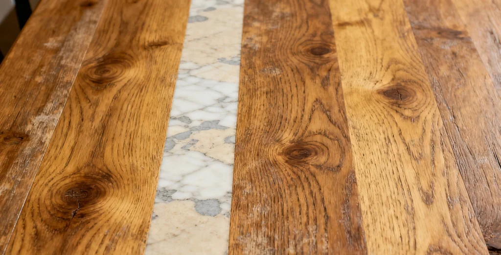 The Real Guide for Restaurant Owners: Choosing the Right Tabletop for Custom Restaurant Furniture4 Laminate restaurant table surface with mixed wood and marble textures for modern dining interiors