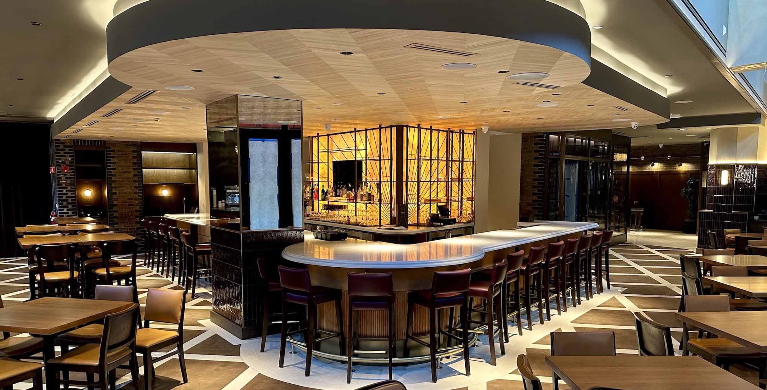 Modern restaurant bar area furnished with MINGMENG bar chairs and tables in warm wood tones