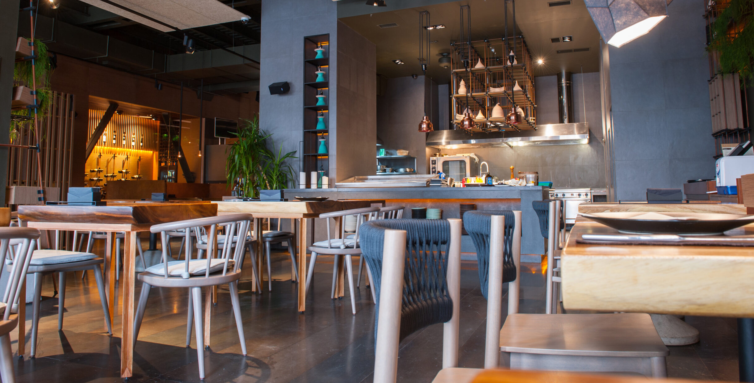Mingmeng café table and chair set in natural wood finish with steel legs inside modern restaurant interior