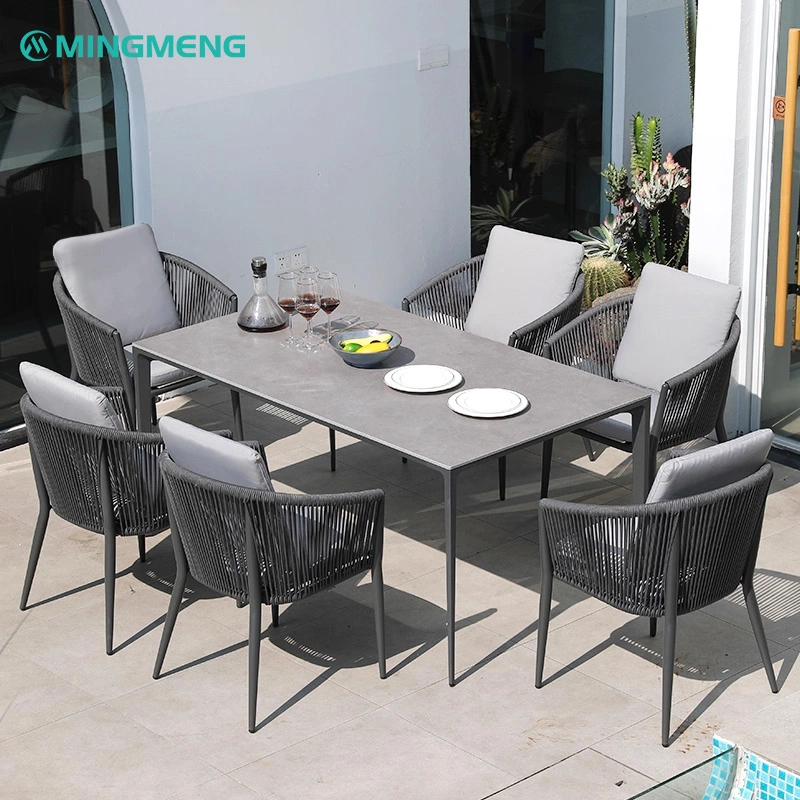 Outdoor Garden Dining Table With Sintered Stone Top1 Modern outdoor dining table set with six rattan backrest chairs and a gray ceramic tabletop, ideal for restaurant patios, cafes, and outdoor dining areas.