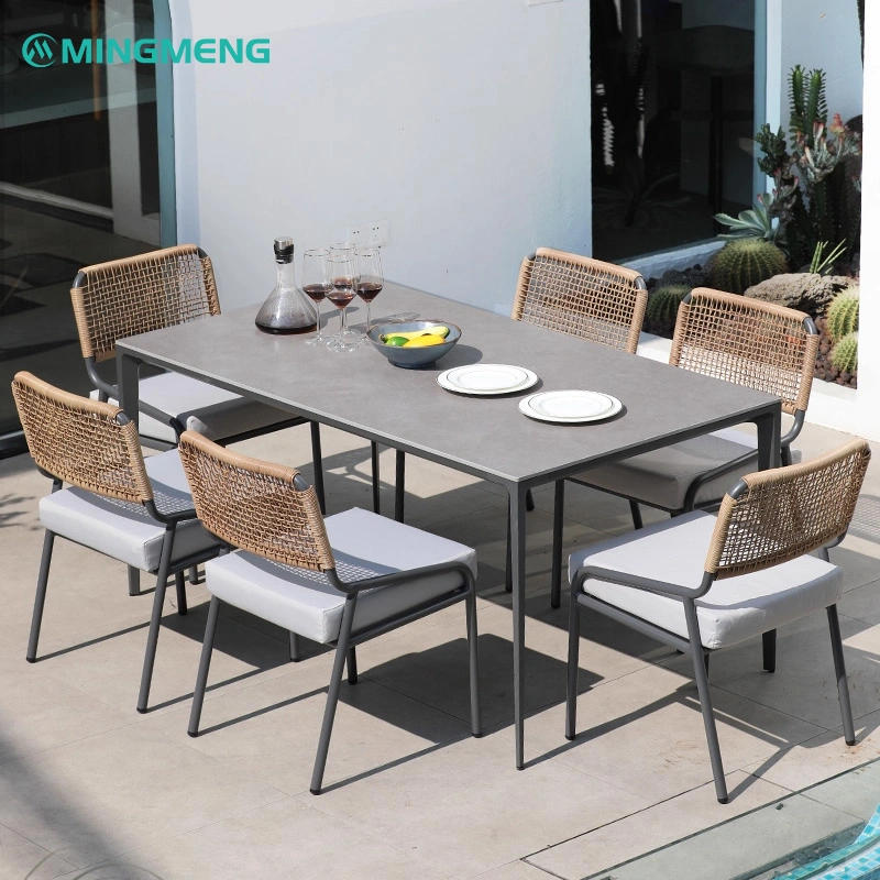 Outdoor Garden Dining Table With Sintered Stone Top2 Modern outdoor dining table set featuring a sleek gray ceramic tabletop and six beige rope chairs, perfect for restaurants, patios, and outdoor dining spaces.