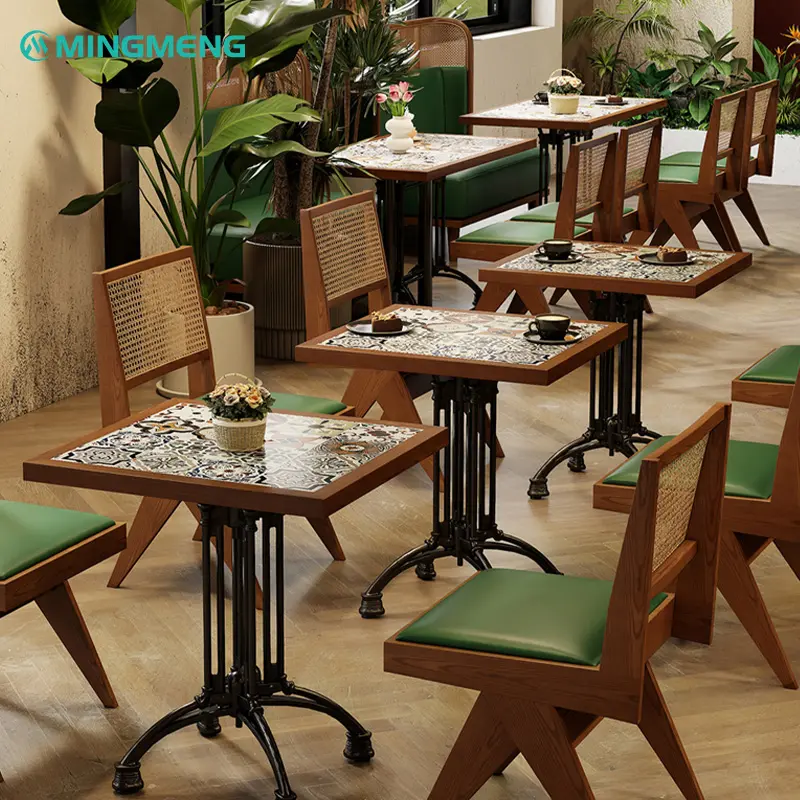 Colorful Vintage Ceramic Restaurant Table1 Restaurant dining area with colorful ceramic tile tables, wooden frames, and green cushioned chairs