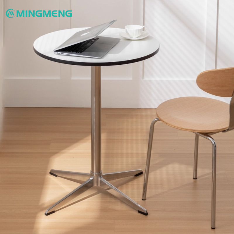 Chrome stainless steel restaurant table base with white tabletop in modern café setting