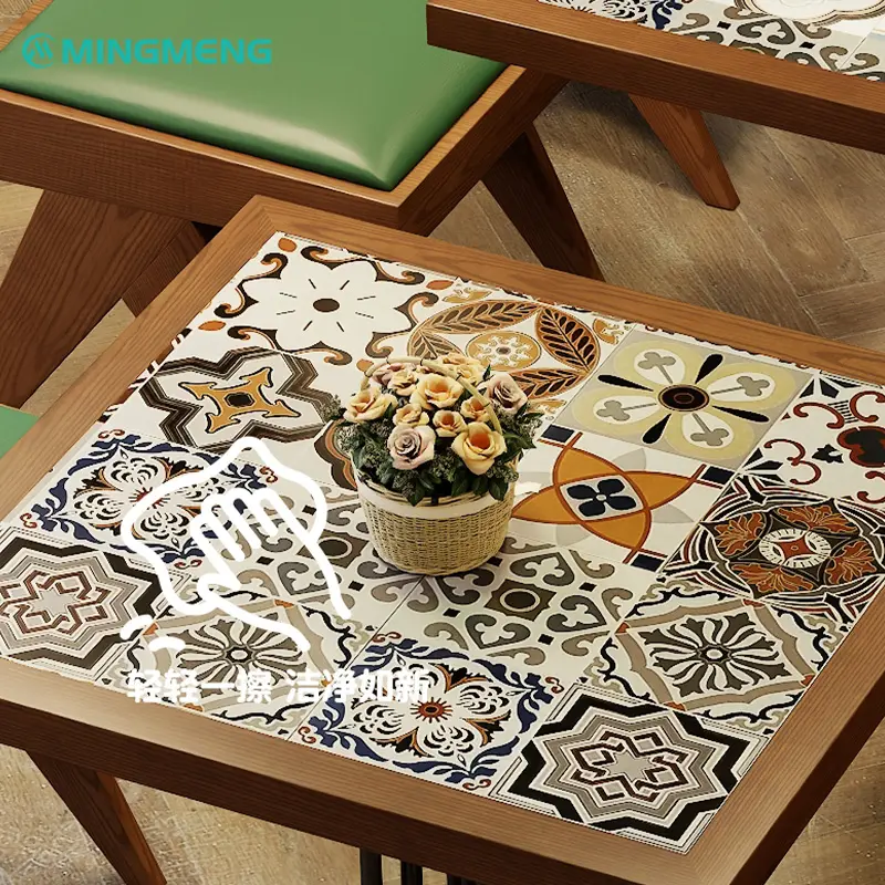 Colorful Vintage Ceramic Restaurant Table Close-up view of a vibrant ceramic tile tabletop framed in wood — featuring intricate floral and geometric patterns that add warmth and personality to restaurant interiors.